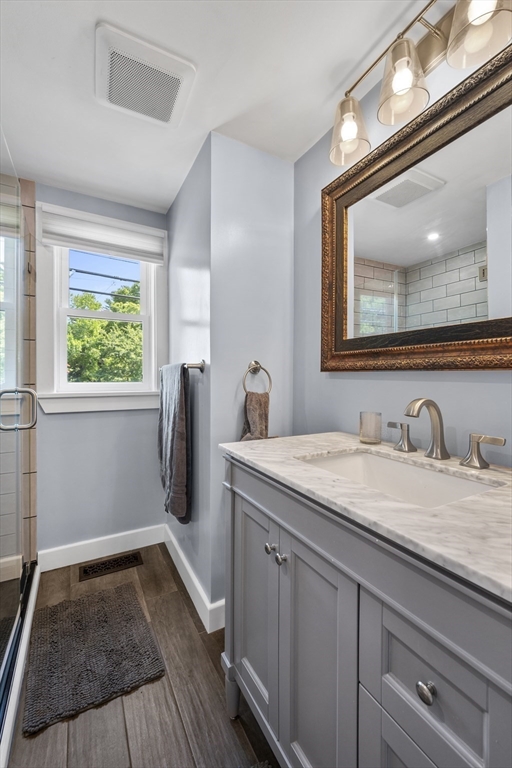 63 River Street Andover, MA 01810 - Photo 29 of 40 a en suite bathroom with a granite countertop sink and a mirror