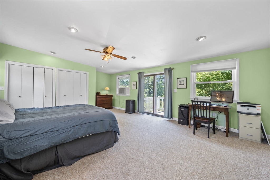 63 River Street Andover, MA 01810 - Photo 31 of 40 a spacious bedroom with a bed and a table in it