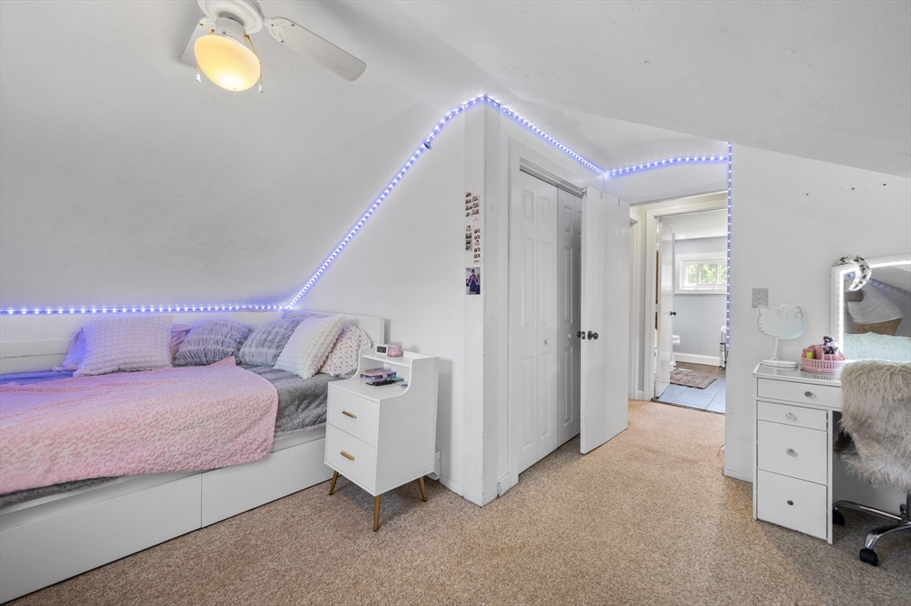 63 River Street Andover, MA 01810 - Photo 37 of 40 a bedroom with a bed and a cabinets