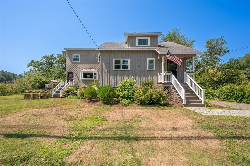 63 River Street Andover, MA 01810 - Photo 10 of 40 a front view of a house with a yard