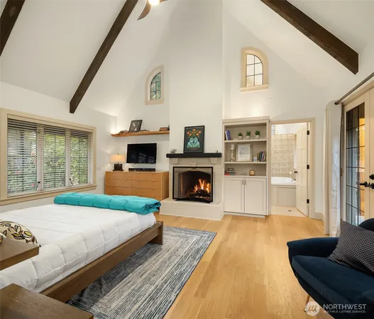 a spacious bedroom with a bed and a fireplace