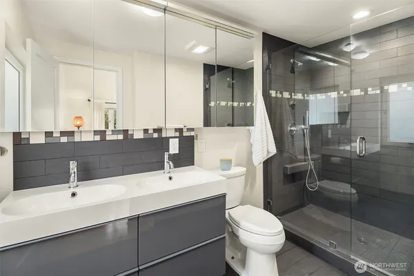 a bathroom with a sink toilet and shower