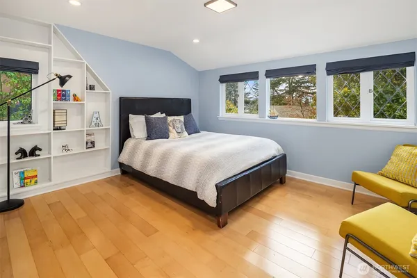 a bed sitting in a bedroom next to a window