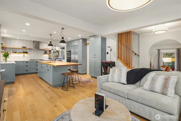 a living room with furniture and a dining table with kitchen view