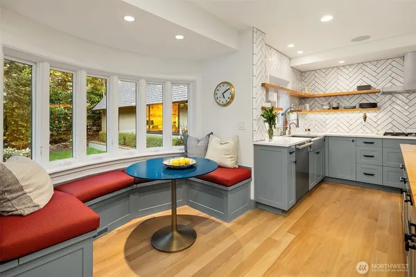 a kitchen with a sink appliances and cabinets