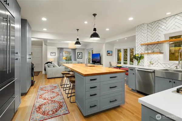 a kitchen with stainless steel appliances granite countertop sink stove and refrigerator