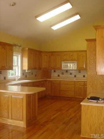 1285 Christmas Tree Road Dunn, NC 28334 - Photo 3 of 5 a view of a kitchen with wooden floor