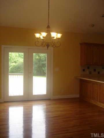 1285 Christmas Tree Road Dunn, NC 28334 - Photo 4 of 5 a view of a room with wooden floor and windows
