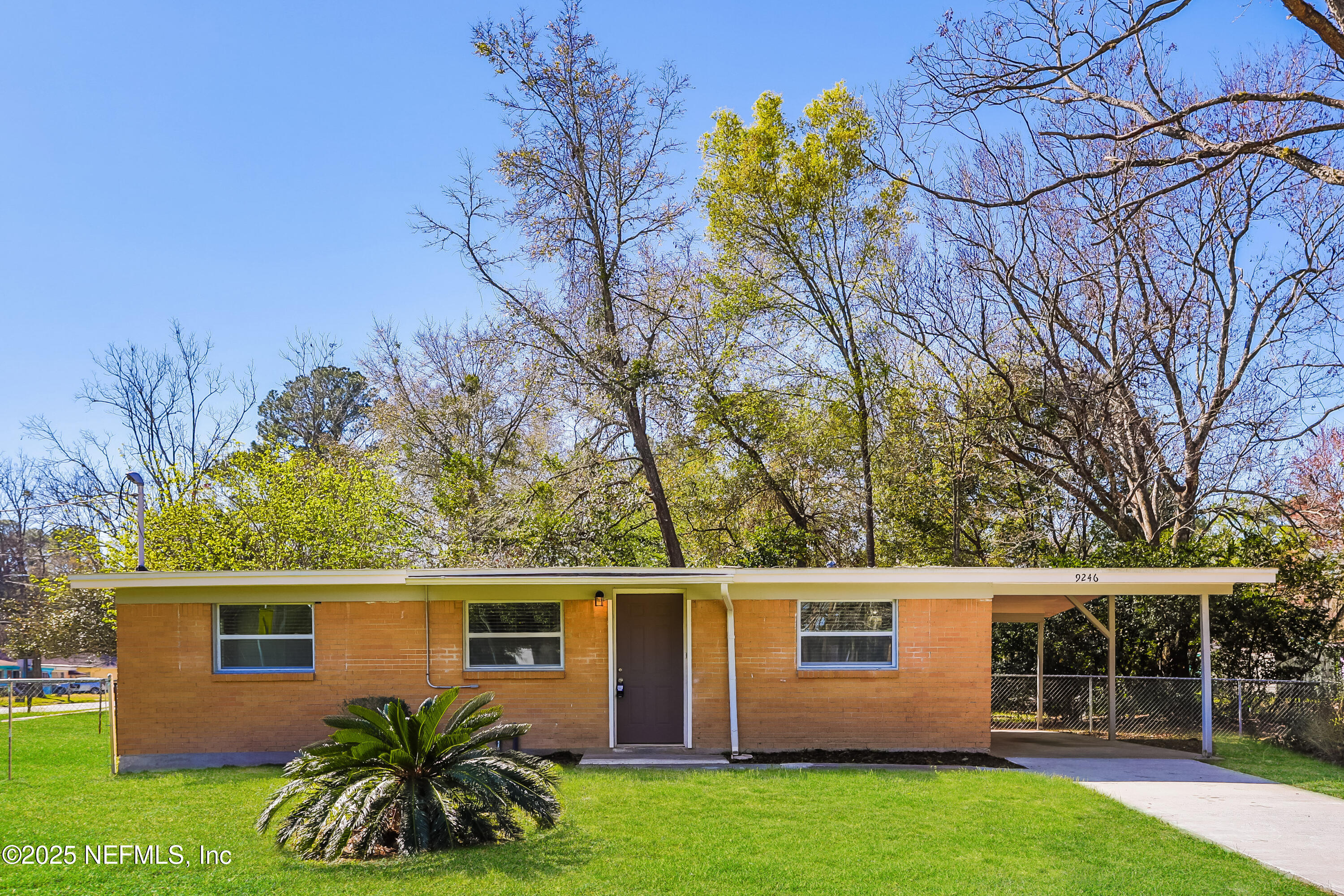 9246 Spottswood Road Jacksonville, FL 32208 - Photo 2 of 15 front view of a house with a yard