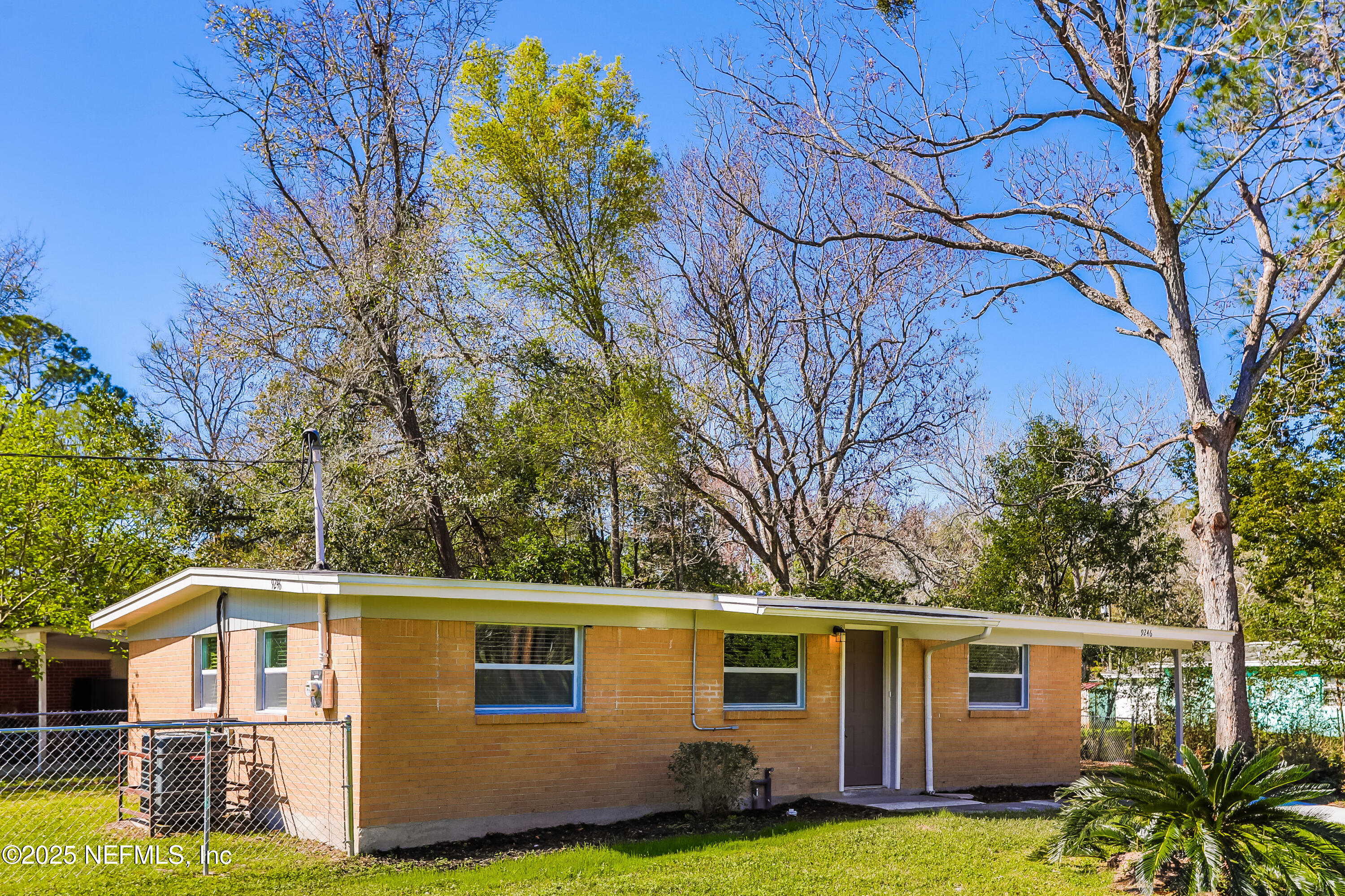 9246 Spottswood Road Jacksonville, FL 32208 - Photo 3 of 15 a front view of a house with garden