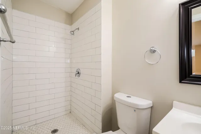a bathroom with a shower a toilet and sink