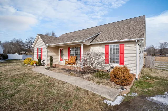 a view of house with backyard space and porch