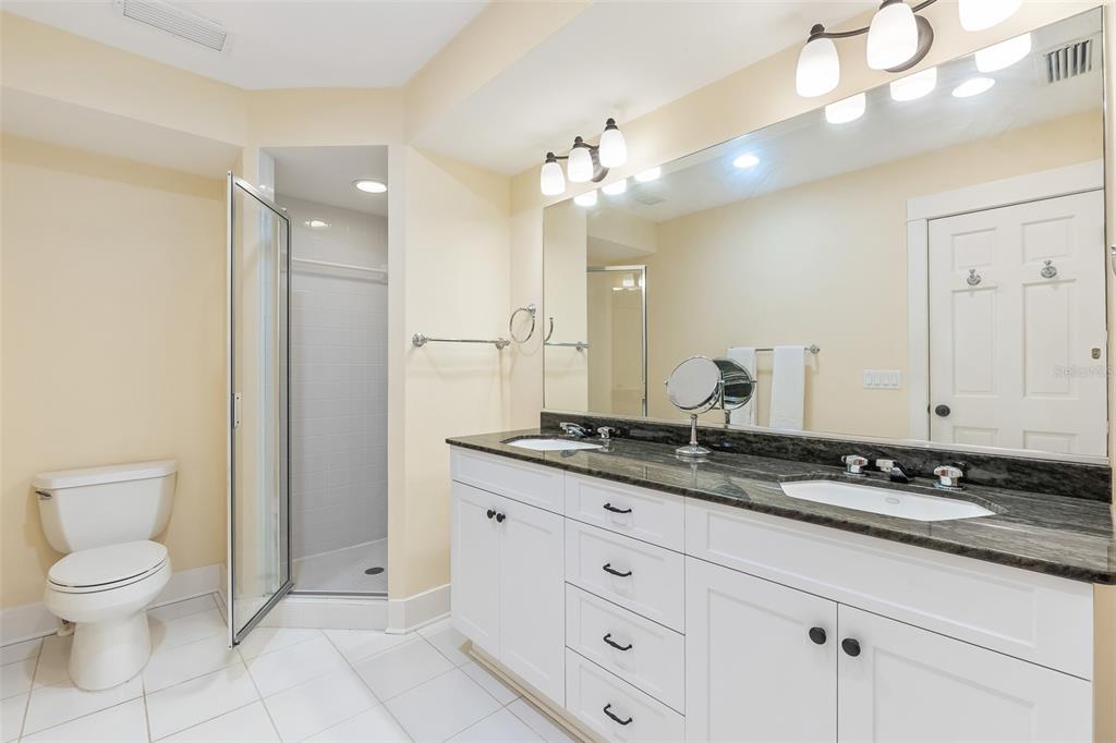 160 1st Street East Boca Grande, FL 33921 - Photo 14 of 43 a bathroom with a granite countertop sink a toilet and a mirror