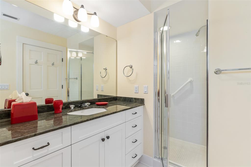 160 1st Street East Boca Grande, FL 33921 - Photo 19 of 43 a bathroom with a granite countertop sink shower and a mirror