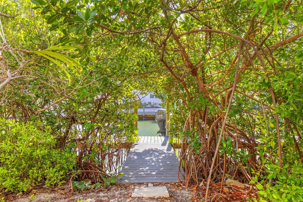 160 1st Street East Boca Grande, FL 33921 - Photo 35 of 43 a front view of a house with a yard and fountain