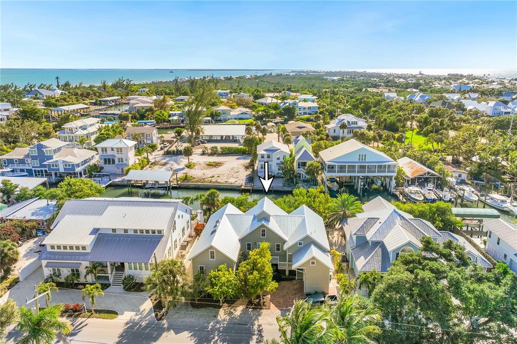 160 1st Street East Boca Grande, FL 33921 - Photo 38 of 43 an aerial view of residential houses with outdoor space and trees