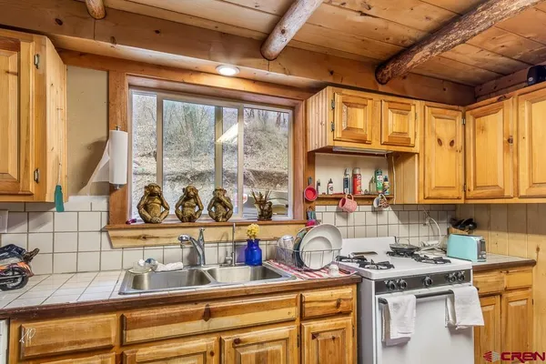a kitchen with a stove a sink and a microwave