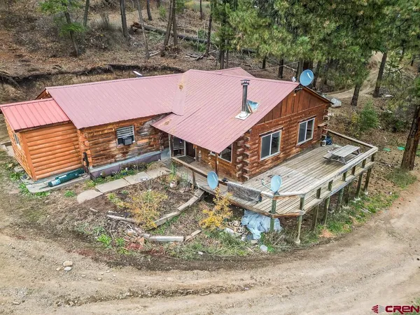 an aerial view of a house with a yard
