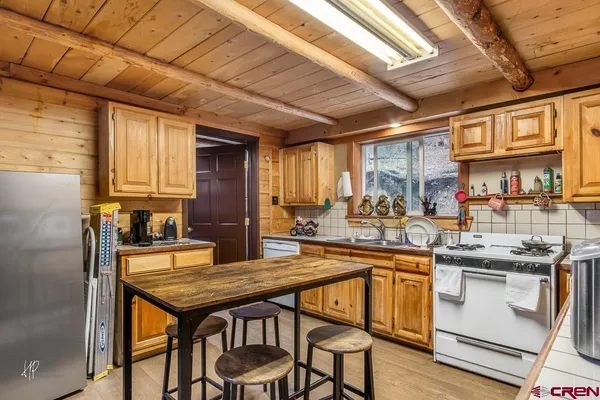 a kitchen with a table chairs stove and cabinets
