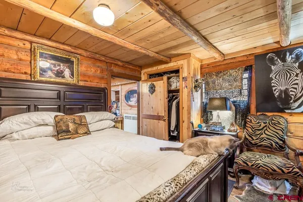 a bedroom with a bed and a desk
