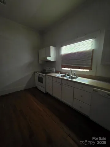 a kitchen with stainless steel appliances a sink stove and cabinets