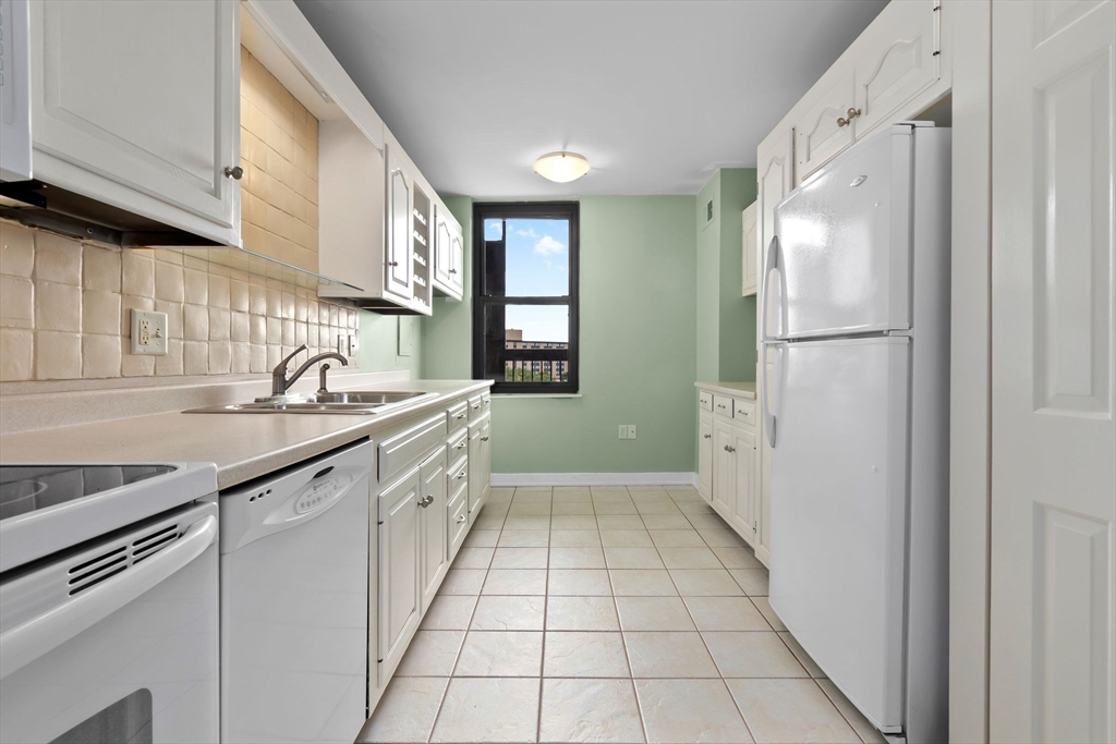 40 Village Road, Unit 1601 Middleton, MA 01949 - Photo 18 of 38 a kitchen with granite countertop a sink appliances cabinets and counter space