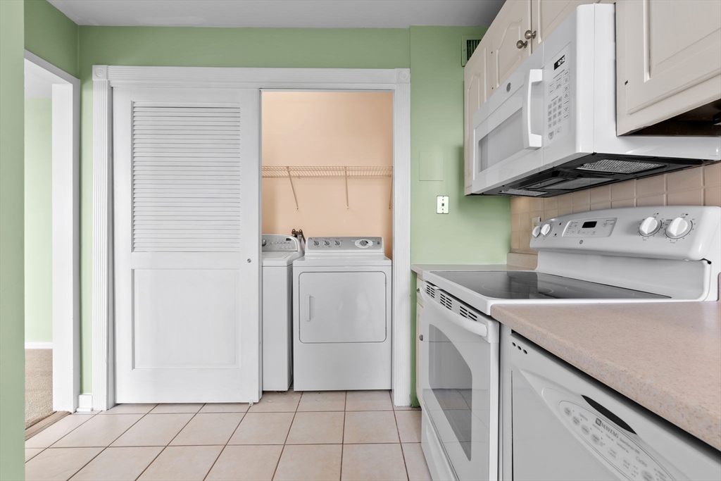 40 Village Road, Unit 1601 Middleton, MA 01949 - Photo 19 of 38 a utility room with cabinets washer and dryer