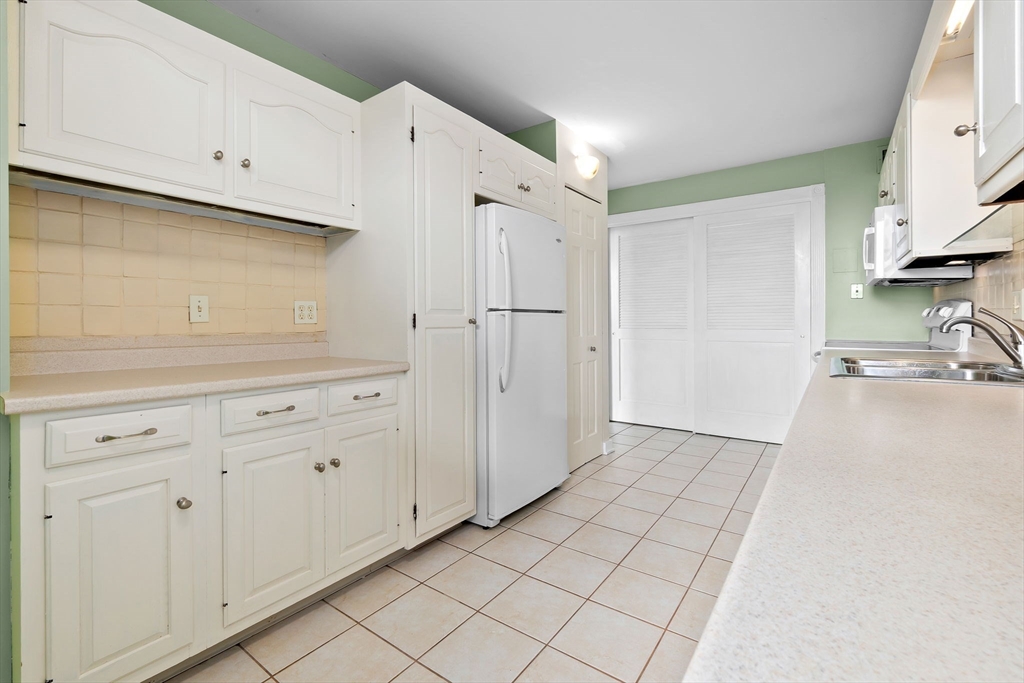 40 Village Road, Unit 1601 Middleton, MA 01949 - Photo 20 of 38 a view of a kitchen with white cabinets