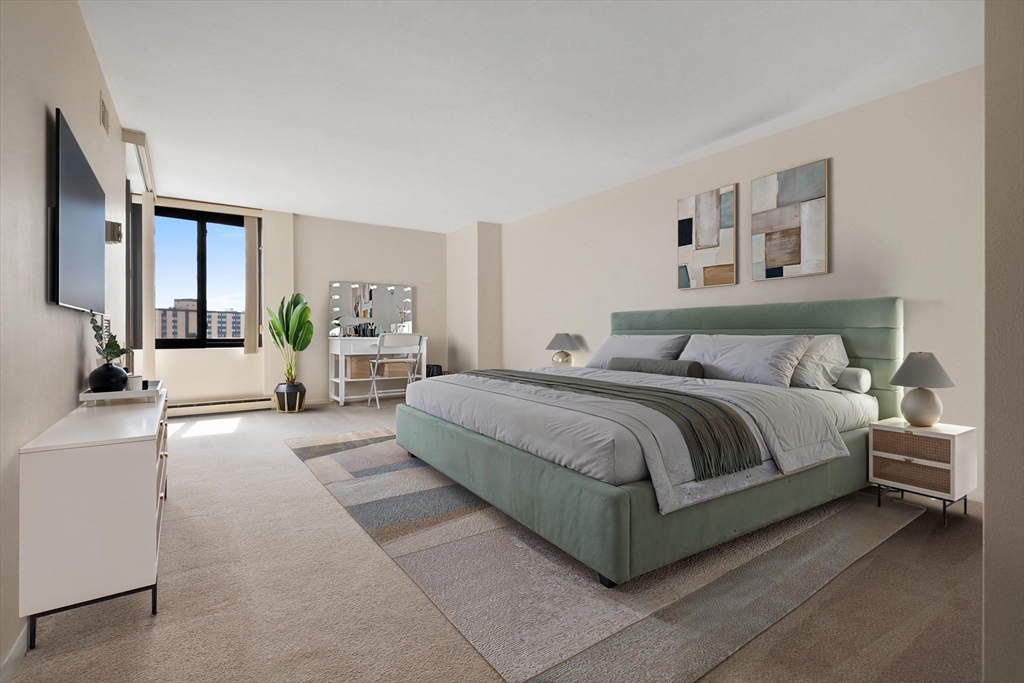 40 Village Road, Unit 1601 Middleton, MA 01949 - Photo 23 of 38 a spacious bedroom with a large bed and a couch