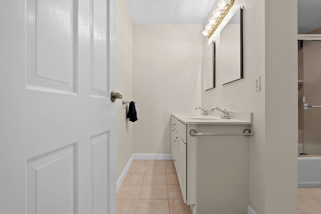 40 Village Road, Unit 1601 Middleton, MA 01949 - Photo 27 of 38 a bathroom with a sink a toilet and mirror