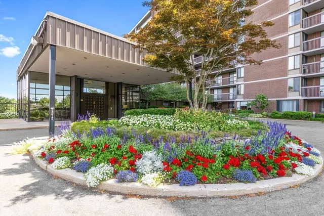 a front view of a house with a yard and fountain