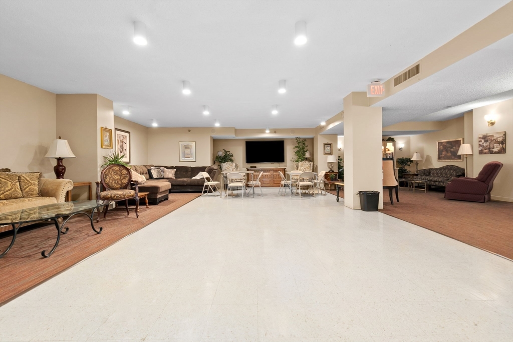 40 Village Road, Unit 1601 Middleton, MA 01949 - Photo 33 of 38 a living room with furniture and a flat screen tv