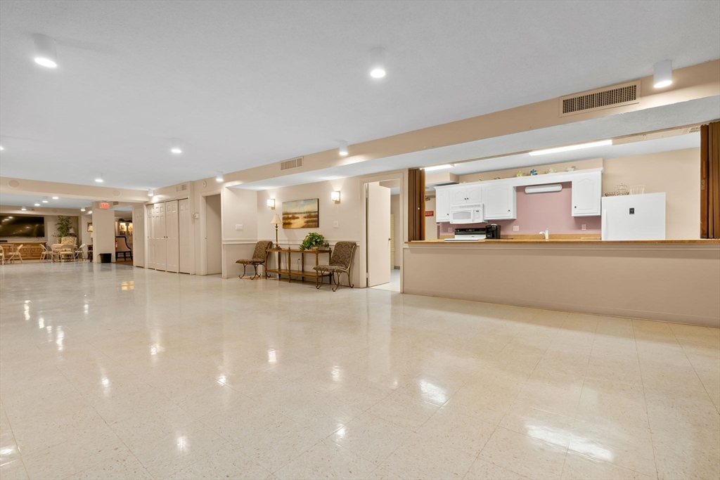 40 Village Road, Unit 1601 Middleton, MA 01949 - Photo 34 of 38 a large white kitchen with a lot of furniture and a large window