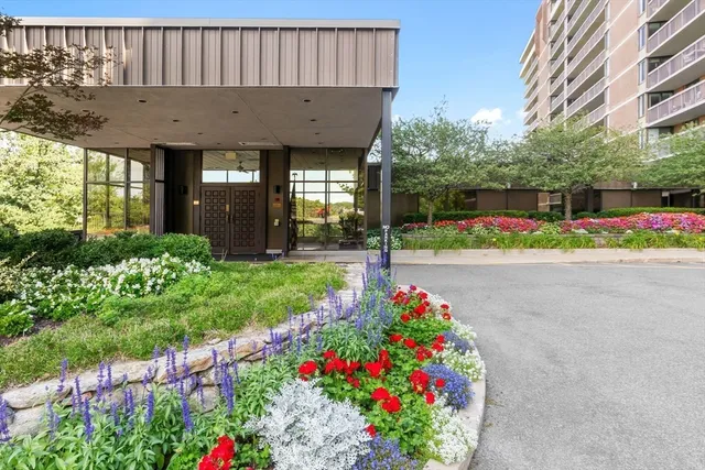 a living room with patio furniture and a potted plants
