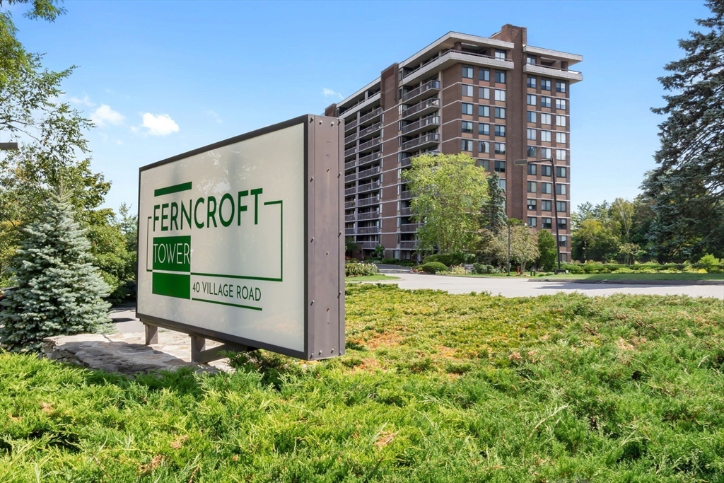 40 Village Road, Unit 1601 Middleton, MA 01949 - Photo 7 of 38 a sign board in front of a brick building