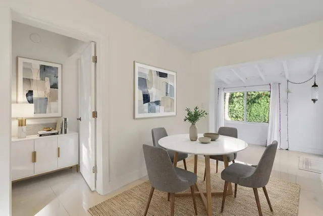 a dining room with furniture and window