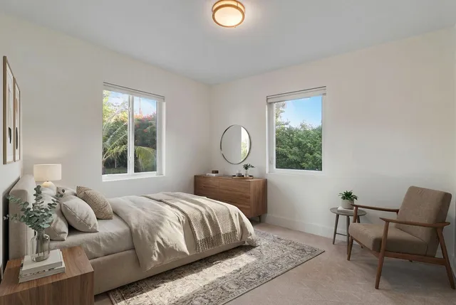 a bedroom with a bed lamp and window
