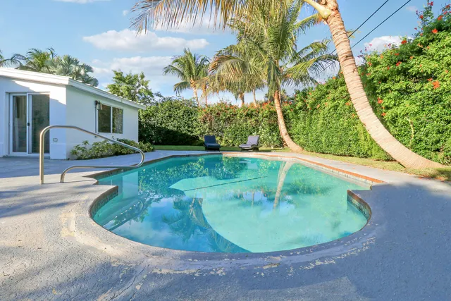 a view of a swimming pool with a yard