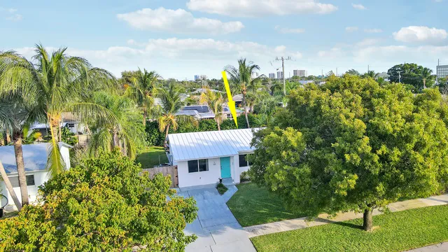a view of a house with a yard and garden