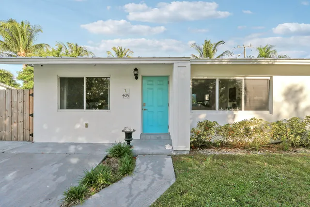 a view of a house with potted plants
