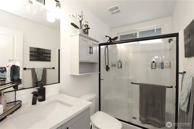 a bathroom with a sink toilet and shower