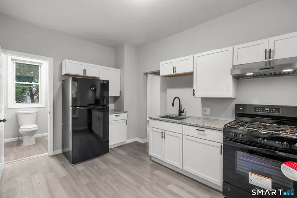 a kitchen with a sink a stove and refrigerator