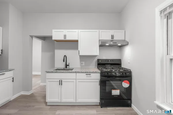 a kitchen with stainless steel appliances granite countertop a stove and cabinets