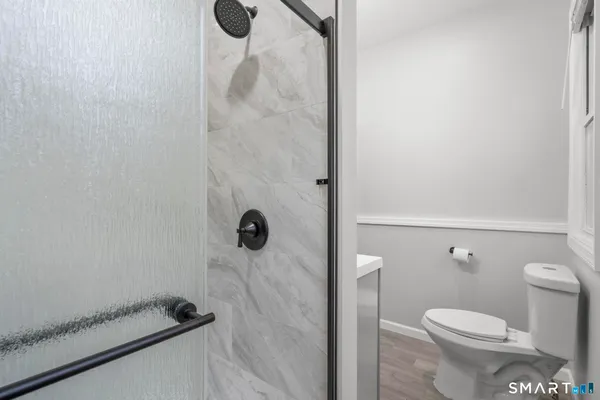 a bathroom with a toilet and a shower