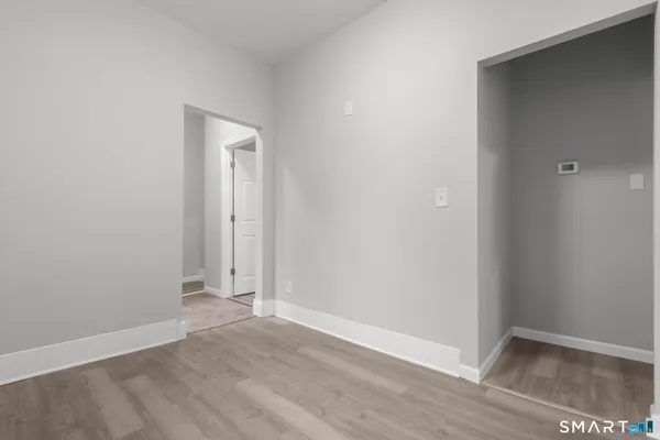 a view of an empty room with wooden floor