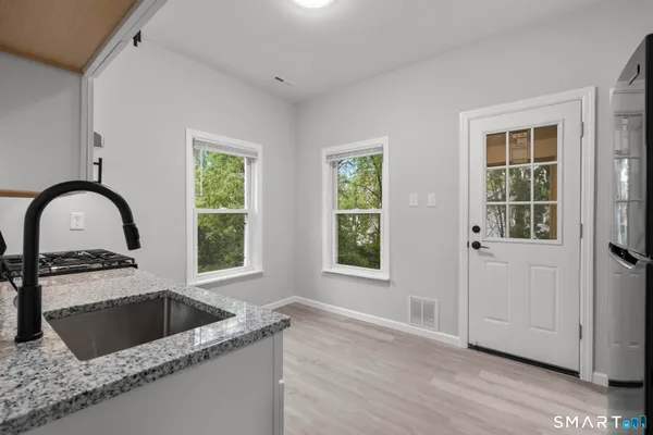 a kitchen with a granite countertop sink a window and a granite counter tops