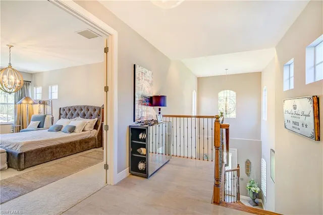 a bedroom with furniture and a large window