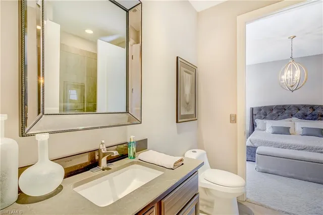 a bathroom with a toilet a sink and a mirror