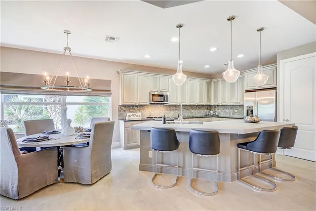a kitchen with a large counter top appliances and cabinets