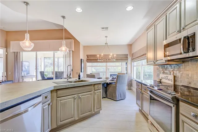 a kitchen with lots of counter space windows and a sink